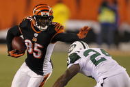 CINCINNATI - JANUARY 9:  Chad Ochocinco #85 of the Cincinnati Bengals runs after a catch before being tackled by Darrelle Revis #24 of the New York Jets in the fourth quarter during the 2010 AFC wild-card playoff game at Paul Brown Stadium on January 9, 2010 in Cincinnati, Ohio. (Photo by Jonathan Daniel/Getty Images)