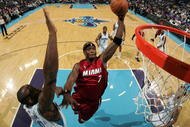 NEW ORLEANS - DECEMBER 30: Jermaine O'Neal #7 of the Miami Heat dunks the ball over Emeka Okafor #50 of the New Orleans Hornets at New Orleans Arena on December 30, 2009 in New Orleans, Louisiana. The Hornets defeated the Heat 95-91. NOTE TO USER: User expressly acknowledges and agrees that, by downloading and/or using this Photograph, User is consenting to the terms and conditions of the Getty Images License Agreement. (Photo by Chris Graythen/Getty Images)