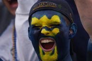 MORGANTOWN, WV - OCTOBER 26:  A fan of the West Virginia University Mountaineers cheers on his team during a Big East game against the University of Miami Hurricanes on October 26, 2002 at Mountaineer Field in Morgantown, West Virginia . Miami won 40-23.  (Photo By Doug Pensinger/Getty Images)