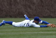 CHICAGO - APRIL 15: Reed Johnson of the Chicago Cubs, wearing a #42 jersey for Jackie Robinson Day, bobbles a catch in center field in the 2nd inning against the Colorado Rockies on April 15, 2009 at Wrigley Field in Chicago, Illinois. The Rockies defeated the Cubs 5-2. (Photo by Jonathan Daniel/Getty Images)