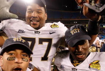 CHARLOTTE, NC - DECEMBER 26:  Teammates Jason Pinkston #77 and Dion Lewis #28 of the Pittsburgh Panthers celebrates after a 19-17 victory over the North Carolina Tar Heels on December 26, 2009 in Charlotte, North Carolina.  (Photo by Streeter Lecka/Getty Images)