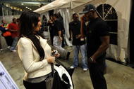 NEW ORLEANS - JANUARY 24:  Kim Kardashian looks on as her boyfriend Reggie Bush (R) of the New Orleans Saints talks on the phone after his team's victor against the Minnesota Vikings to win the NFC Championship Game at the Louisana Superdome on January 24, 2010 in New Orleans, Louisiana.  (Photo by Michael Heiman/Getty Images)