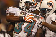 CHARLOTTE - NOVEMBER 19: Ricky Williams #34 of the Miami Dolphins celebrates with teammates after he scored on a 14 yard touchdown reception in the second quarter against the Carolina Panthers at Bank of America Stadium on November 19, 2009 in Charlotte, North Carolina.  (Photo by Streeter Lecka/Getty Images)