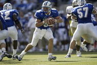 SEATTLE - SEPTEMBER 3:  Quarterback Shaun Carney #5 of Air Force rolls out to pass against the Washington Huskies on September 3, 2005 at Quest Field in Seattle, Washington. (Photo by Otto Greule Jr/Getty Images) 