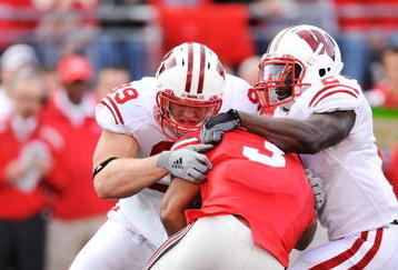 COLUMBUS, OH - OCTOBER 10:  J.J. Watt #99 and Jay Valai #2 of the Wisconsin Badgers make a tackle on Brandon Saine #3 of the Ohio State Buckeyes at Ohio Stadium on October 10, 2009 in Columbus, Ohio.  (Photo by Jamie Sabau/Getty Images)