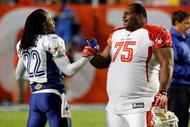 MIAMI GARDENS, FL - JANUARY 31:  Former Patriots teammates Asante Samuel #22 of the NFC's Philadelphia Eagles and Vincent Wilfork #75 of the AFC's New England Patriots greet one another on the field during the 2010 AFC-NFC Pro Bowl game at Sun Life Stadium on January 31, 2010 in Miami Gardens, Florida. The AFC defeated the NFC 41-34. (Photo by Scott Halleran/Getty Images)