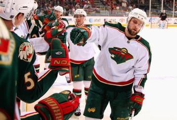 GLENDALE, AZ - JANUARY 16:  Guillaume Latendresse #48 of the Minnesota Wild celebrates with teammates on the bench after scoring a second period goal against the Phoenix Coyotes during the NHL game at Jobing.com Arena on January 16, 2010 in Glendale, Arizona.  (Photo by Christian Petersen/Getty Images)