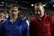 MIAMI GARDENS, FL - JANUARY 31:  Drew Brees (L) of the New Orleans Saints and Peyton Manning of the Indianapolis Colts walk on the field during 2010 AFC-NFC Pro Bowl at Sun Life Stadium on January 31, 2010 in Miami Gardens, Florida.  (Photo by Scott Halleran/Getty Images)