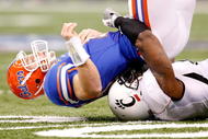 NEW ORLEANS - JANUARY 01:  Alex Daniels #4 of the Cincinnati Bearcats sacks quarterback Tim Tebow #15 of the Florida Gators during the Allstate Sugar Bowl at the Louisana Superdome on January 1, 2010 in New Orleans, Louisiana.  (Photo by Kevin C. Cox/Getty Images)