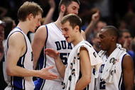 NEW YORK - DECEMBER 19:   Jon Scheyer #30 is greeted by Kyle Singler #12, Brian Zoubek #55 and Nolan Smith #2 of the Duke Blue Devils after win over the Gonzaga Bulldogs in the second half of the Aeropostale Classic at Madison Square Garden on December 19, 2009 in New York City.  (Photo by Jeff Zelevansky/Getty Images)