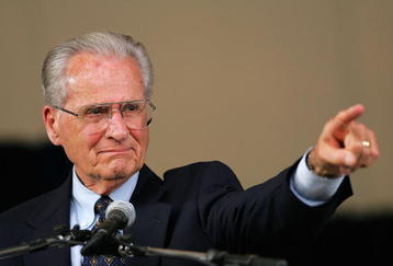 COOPERSTOWN, NY - JULY 31:  Jerry Coleman points to his wife in the crowd after receiving the Ford C. Frick Award, presented annually to a baseball broadcaster for major contributions to the game, during the Baseball Hall of Fame induction ceremony on July 31, 2005 at the Clark Sports Complex in Cooperstown, New York.  (Photo by Ezra Shaw/Getty Images)