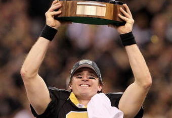 NEW ORLEANS - JANUARY 24:  Drew Brees #9 of the New Orleans Saints celebrates with the George S. Halas Trophy after the Saints won 31-28 in overtime against the Minnesota Vikings during the NFC Championship Game at the Louisiana Superdome on January 24, 2010 in New Orleans, Louisiana.  (Photo by Jed Jacobsohn/Getty Images)