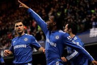 LONDON, ENGLAND - FEBRUARY 07:  Didier Drogba of Chelsea celebrates scoring the first goal of the game with team mates during the Barclays Premier League match between Chelsea and Arsenal at Stamford Bridge on February 7, 2010 in London, England.  (Photo by Paul Gilham/Getty Images)