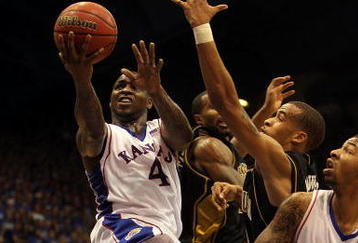 LAWRENCE, KS - JANUARY 25:  Sherron Collins #4 of the Kansas Jayhawks goes up for a layup during the game against the Missouri Tigers on January 25, 2010 at Allen Fieldhouse in Lawrence, Kansas.  (Photo by Jamie Squire/Getty Images)
