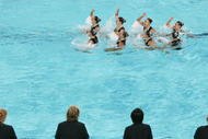 ATHENS - AUGUST 27:  The judges watch as team Canada performs in the team free routine event on August 27, 2004 during the Athens 2004 Summer Olympic Games at the Synchronised Swimming Pool in the Olympic Sports Complex Aquatic Centre in Athens, Greece. (Photo by Daniel Berehulak/Getty Images for FINA)