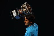 MELBOURNE, AUSTRALIA - JANUARY 31: Roger Federer of Switzerland holds aloft the Norman Brookes Challenge Cup after his men's final match against Andy Murray of Great Britain during day fourteen of the 2010 Australian Open at Melbourne Park on January 31, 2010 in Melbourne, Australia. (Photo by Lucas Dawson/Getty Images)