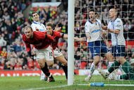 MANCHESTER, ENGLAND - FEBRUARY 06:  Wayne Rooney of Manchester United celebrates scoring to make it 1-0 during the Barclays Premier League match between Manchester United and Portsmouth at Old Trafford on February 6, 2010 in Manchester, England.  (Photo by Michael Regan/Getty Images)