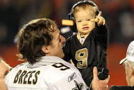 MIAMI GARDENS, FL - FEBRUARY 07: Drew Brees #9 of the New Orleans Saints celebrates with his son Baylen Brees as his wife Brittany Brees looks on after defeating the Indianapolis Colts during Super Bowl XLIV on February 7, 2010 at Sun Life Stadium in Miami Gardens, Florida. (Photo by Ronald Martinez/Getty Images)