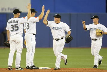 TORONTO - APRIL 6: (L-R) Lyle Overbay #35, Scott Rolen #33, Travis Snider #45, Aaron Hill #2 of the Toronto Blue Jays celebrate the win over the Detroit Tigers during the Opening Day game at the Rogers Centre on April 6, 2009 in Toronto, Ontario. (Photo by: Dave Sandford/Getty Images)