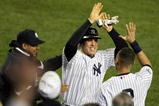 NEW YORK - NOVEMBER 04:  Mark Teixeira #25 (C) and Derek Jeter #2 of the New York Yankees celebrate after Teixeira scored in the bottom of the fifth inning against the Philadelphia Phillies in Game Six of the 2009 MLB World Series at Yankee Stadium on November 4, 2009 in the Bronx borough of New York City.  (Photo by Al Bello/Getty Images)