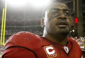 GLENDALE, AZ - JANUARY 10:  Linebacker Karlos Dansby #58 of the Arizona Cardinals walks off the field after defeating the Green Bay Packers 51-45 in the 2010 NFC wild-card playoff game at University of Phoenix Stadium on January 10, 2010 in Glendale, Arizona.   (Photo by Jeff Gross/Getty Images)