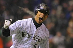DENVER - OCTOBER 11:  Carlos Gonzalez #5 of the Colorado Rockies reacts after hitting a home run in the bottom of the fourth inning against the Philadelphia Phillies in Game Three of the NLDS during the 2009 MLB Playoffs at Coors Field on October 11, 2009 in Denver, Colorado.  (Photo by Doug Pensinger/ Getty Images)