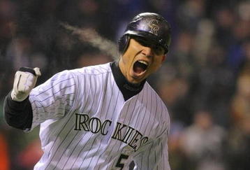 DENVER - OCTOBER 11:  Carlos Gonzalez #5 of the Colorado Rockies reacts after hitting a home run in the bottom of the fourth inning against the Philadelphia Phillies in Game Three of the NLDS during the 2009 MLB Playoffs at Coors Field on October 11, 2009 in Denver, Colorado.  (Photo by Doug Pensinger/ Getty Images)