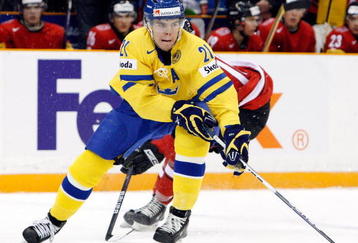 SASKATOON, SK - JANUARY 5:  Magnus Paajarvi-Svensson #21 of Team Sweden skates with the puck while being defended by Jeffrey Fuglister #15 of Team Switzerland during the 2010 IIHF World Junior Championship Tournament Bronze Medal game on January 5, 2010 at the Credit Union Centre in Saskatoon, Saskatchewan, Canada.  Team Sweden defeated Team Switzerland 11-4.  (Photo by Richard Wolowicz/Getty Images)