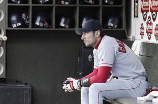 OAKLAND, CA - OCTOBER 6:  Nomar Garciaparra #5 of the Boston Red Sox sits in the dugout as he gets ready for the start of Game 5 of the 2003 American League Divisional Series against the Oakland A's on October 6, 2003 at Network Associates Coliseum in Oakland, California.  The Red Sox defeated the A's 4-3.  (Photo by Jed Jacobsohn/Getty Images)
