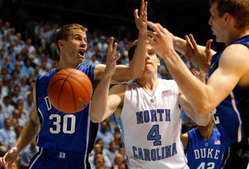 CHAPEL HILL, NC - MARCH 08:  Teammates Jon Scheyer #30 and Kyle Singler #12 of the Duke Blue Devils try to grab a loose ball against Bobby Frasor #4 of the North Carolina Tar Heels during their game at the Dean E. Smith Center on March 8, 2009 in Chapel Hill, North Carolina.  (Photo by Streeter Lecka/Getty Images)