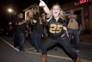 NEW ORLEANS - FEBRUARY 07: Exuberant New Orleans Saints fans celebrating their first ever Super Bowl victory as the crowds spill out on to the streets in front of the Mid-City neighborhood bar Red Door on February 7, 2010 in New Orleans, Louisiana. (Photo by Skip Bolen/Getty Images)