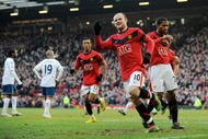 MANCHESTER, ENGLAND - FEBRUARY 06:  Wayne Rooney of Manchester United celebrates scoring to make it 1-0 during the Barclays Premier League match between Manchester United and Portsmouth at Old Trafford on February 6, 2010 in Manchester, England.  (Photo by Michael Regan/Getty Images)