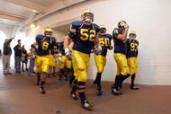 ANN ARBOR, MI - NOVEMBER 21: Kevin Leach #52 of the Michigan Wolverines jogs through the tunnel before the game against the Ohio State Buckeyes on November 21, 2009 at Michigan Stadium in Ann Arbor, Michigan. Ohio State won the game 21-10. (Photo by Gregory Shamus/Getty Images)