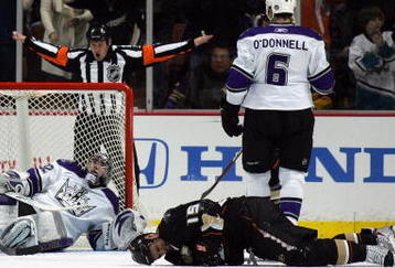ANAHEIM, CA - FEBRUARY 08:  NHL referee Kelly Sutherland signals no goal as goaltender Jonathan Quick #32 of the Los Angeles Kings looks on from his net and Ryan Getzlaf #15 of the Anaheim Ducks writhes in pain on the ice after injuring his ankle in the play in the second period during their NHL game at the Honda Center on February 8, 2010 in Anaheim, California. The Ducks defeated the Kings 4-2. (Photo by Victor Decolongon/Getty Images)