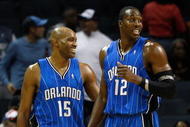 CHARLOTTE, NC - NOVEMBER 10:  Teammates Vince Carter #15 and Dwight Howard #12 of the Orlando Magic look over at the bench of the Charlotte Bobcats during their game at Time Warner Cable Arena on November 10, 2009 in Charlotte, North Carolina.  (Photo by Streeter Lecka/Getty Images)