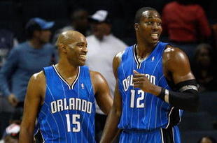 CHARLOTTE, NC - NOVEMBER 10:  Teammates Vince Carter #15 and Dwight Howard #12 of the Orlando Magic look over at the bench of the Charlotte Bobcats during their game at Time Warner Cable Arena on November 10, 2009 in Charlotte, North Carolina.  (Photo by Streeter Lecka/Getty Images)