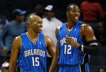 CHARLOTTE, NC - NOVEMBER 10:  Teammates Vince Carter #15 and Dwight Howard #12 of the Orlando Magic look over at the bench of the Charlotte Bobcats during their game at Time Warner Cable Arena on November 10, 2009 in Charlotte, North Carolina.  (Photo by Streeter Lecka/Getty Images)