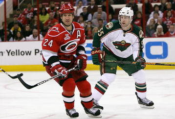 RALEIGH, NC - MARCH 6:  Scott Walker #24 of the Carolina Hurricanes and Nick Schultz #55 of the Minnesota Wild skate on the ice during the NHL game at RBC Center on March 6, 2008 in Raleigh, North Carolina.  Carolina defeated Minnesota 3-2.  (Photo by Kevin C. Cox/Getty Images)