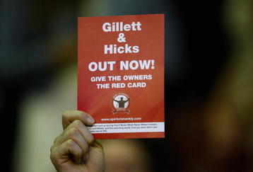 LIVERPOOL, ENGLAND - AUGUST 19:  A  Liverpool fan shows a red card to the club owners during the Barclays Premier League match between Liverpool and Stoke City at Anfield on August 19, 2009 in Liverpool, England.  (Photo by Clive Brunskill/Getty Images)