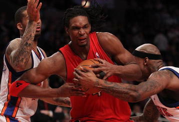NEW YORK - JANUARY 28:  Chris Bosh #4 of the Toronto Raptors drives to the basket between Wilson Chandler #21 and Al Harrington #1 of the New York Knicks at Madison Square Garden on January 28, 2010 in New York, New York. NOTE TO USER: User expressly acknowledges and agrees that, by downloading and or using this photograph, User is consenting to the terms and conditions of the Getty Images License Agreement.  (Photo by Nick Laham/Getty Images)