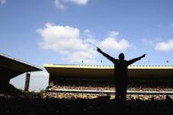 WOLVERHAMPTON, ENGLAND - APRIL 18:  Wolverhampton Wanderers fans cover the pitch after the final whistle to celebrate after winning promotion to the Premier League after the Coca Cola Championship match between Wolverhampton Wanderers and Queens Park Rangers at Molineux Stadium on April 18, 2009 in Wolverhampton, England.  (Photo by Clive Brunskill/Getty Images)