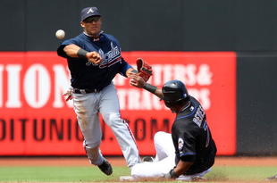 NEW YORK - MAY 13:  Yunel Escobar #19 of the Atlanta Braves completes a double play in the third inning after forcing out Jose Reyes #7 of the New York Mets on May 13, 2009 at Citi Field in the Flushing neighborhood of the Queens borough of New York City.  (Photo by Jim McIsaac/Getty Images)