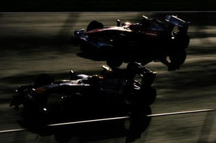 JEREZ DE LA FRONTERA, SPAIN - FEBRUARY 19:  Fernando Alonso (top) of Spain and Ferrari and Mark Webber (bottom) of Australia and Red Bull Racing drive side by side during winter testing at the Circuito De Jerez on February 19, 2010 in Jerez de la Frontera, Spain.  (Photo by Ker Robertson/Getty Images)