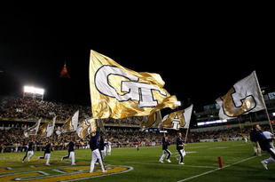 ATLANTA - NOVEMBER 28:  Cheerleaders for the Georgia Tech Yellow Jackets waves flags in the air during the game against the Georgia Bulldogs at Bobby Dodd Stadium on November 28, 2009 in Atlanta, Georgia.  (Photo by Kevin C. Cox/Getty Images)
