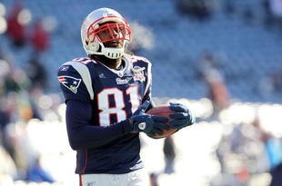FOXBORO, MA - JANUARY 10:  Randy Moss #81 of the New England Patriots looks on during warm ups against the Baltimore Ravens during the 2010 AFC wild-card playoff game at Gillette Stadium on January 10, 2010 in Foxboro, Massachusetts.  (Photo by Jim Rogash/Getty Images)