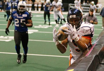 LAS VEGAS - AUGUST 22:  Charles Dillon #5 of the Spokane Shock catches a touchdown pass as Larry Kendrick #25 of the Wilkes-Barre/Scranton Pioneers trails the play during the AFL2 ArenaCup 10 at the Orleans Arena August 22, 2009 in Las Vegas, Nevada. The Shock defeated the Pioneers 74-27.  (Photo by Ethan Miller/Getty Images)