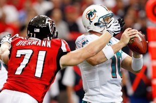 ATLANTA - SEPTEMBER 13:  Kroy Biermann #71 of the Atlanta Falcons forces a fumble by quarterback Chad Pennington #10 of the Miami Dolphins at Georgia Dome on September 13, 2009 in Atlanta, Georgia.  (Photo by Kevin C. Cox/Getty Images)