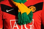 MANCHESTER, ENGLAND - FEBRUARY 06: A Manchester United fan wears a green and yellow scarf before the Barclays Premier League match between Manchester United and Portsmouth at Old Trafford on February 6, 2010 in Manchester, England.  (Photo by Michael Regan/Getty Images)