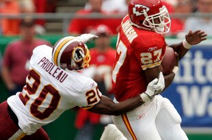 KANSAS CITY, MO - OCTOBER 16:   Larry Johnson #27 of the Kansas City Chiefs runs the ball around Pierson Prioleau #20 of the Washington Redskins in the first half on October 16, 2005 at Arrowhead Stadium in Kansas City, Missouri.  (Photo by Larry W. Smith/Getty Images)