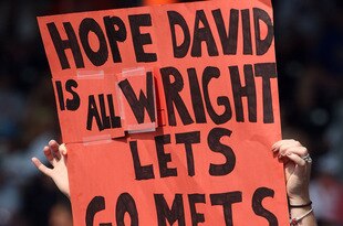 NEW YORK - AUGUST 16:  A fan of the New York Mets holds a banner in reference to injured player David Wright during the game against the San Francisco Giants on August 16, 2009 at Citi Field in the Flushing neighborhood of the Queens borough of New York City.  (Photo by Jim McIsaac/Getty Images)